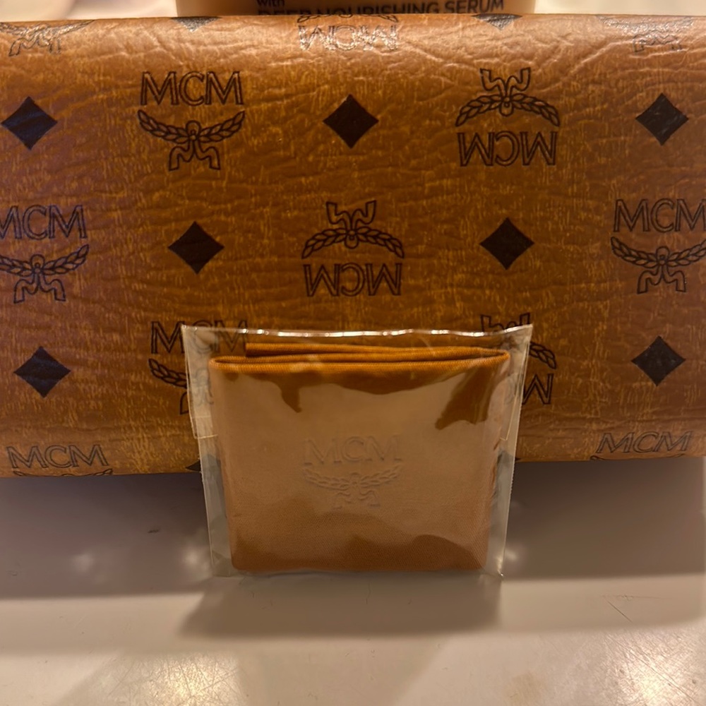 Sunglasses that are by the designer MCM and they are of a creamy color